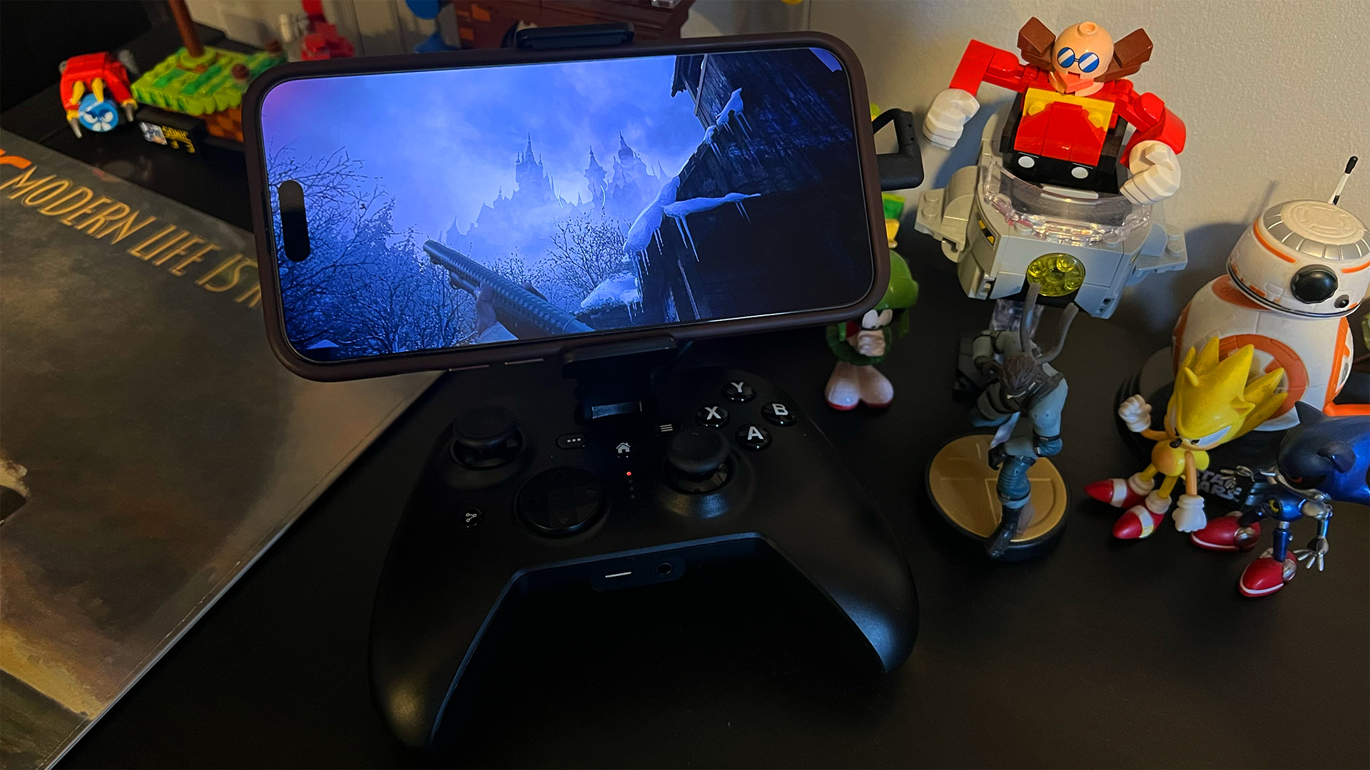 Resident Evil Village on 15 Pro Max with RIOT Controller on desk
